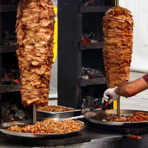 Closeup picture of stacked meat roasting, shawarma